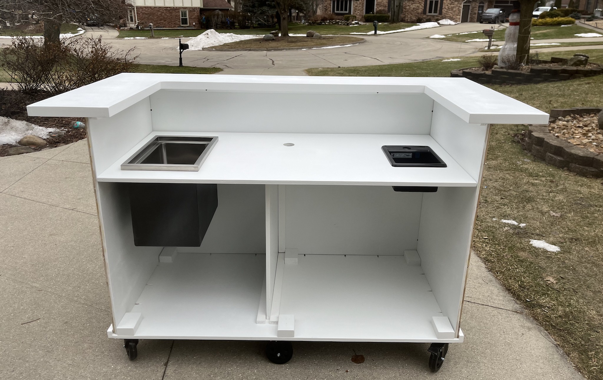 Back of the same two-level bar cart: open serving side with a drop-in ice well and interior storage