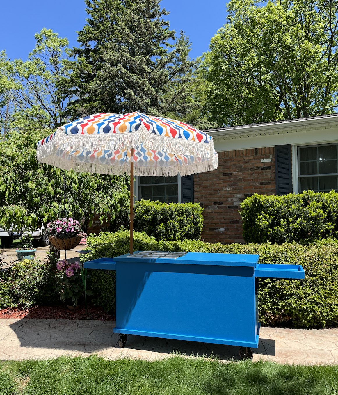 Custom cart painted beachy blue with a colorful confetti-print parasol