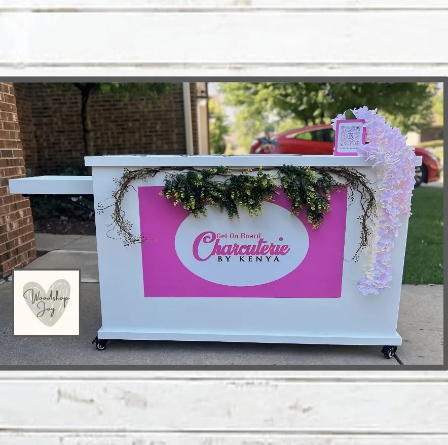 Get On Board Charcuterie by Kenya: a custom cart finished in brand pink with a fold-out shelf, styled with florals